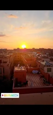 a view of a city with the sunset in the background at Sultana in Marrakech