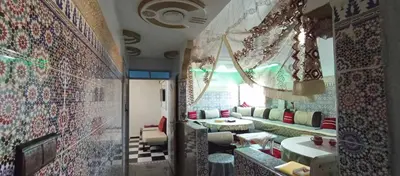 a living room with a couch and a table at Appartement à louer in Marrakech