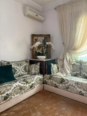 a living room with a couch and a window at BELDI and contemporary elegance in Marrakech