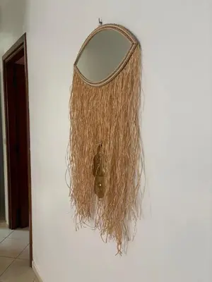a mirror hanging on a wall with a basket at BELDI and contemporary elegance in Marrakech