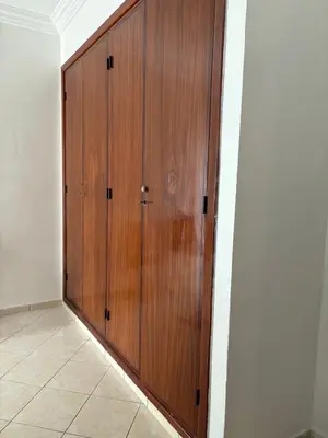 a wooden door in the corner of a room at BELDI and contemporary elegance in Marrakech