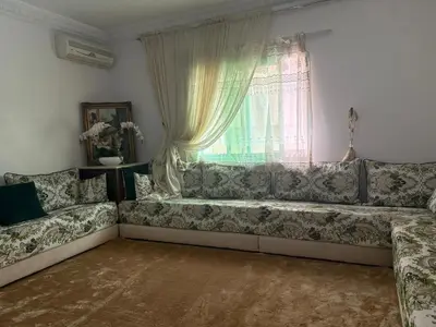 a couch in a living room with a window at BELDI and contemporary elegance in Marrakech