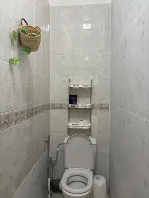 a bathroom with a toilet and a basket on the wall at BELDI and contemporary elegance in Marrakech