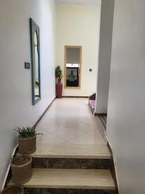 a hallway with a mirror and potted plants at Maison D'hôte Dar ALBIDAWI CH5 in Marrakech