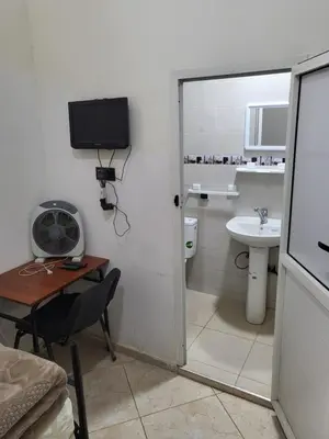 a bathroom with a sink and a toilet and a desk at Maison D'hôte Dar ALBIDAWI CH5 in Marrakech