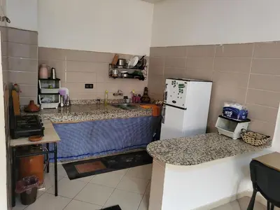 a kitchen with a white refrigerator and a counter at Maison D'hôte Dar ALBIDAWI CH5 in Marrakech