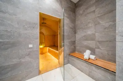 a bathroom with a shower with a glass door at Villa cancun resort Luxury Spa-cinéma & jacuzzi in Marrakech