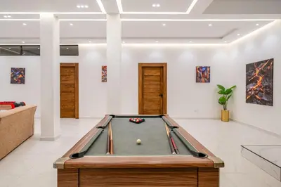 a pool table in the middle of a living room at Villa cancun resort Luxury Spa-cinéma & jacuzzi in Marrakech