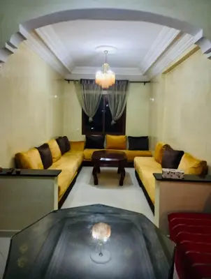 a living room with a couch and a table at Modern 2bedroom full furnished in downtown in Marrakech