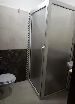 a shower stall in a bathroom with a toilet at Modern 2bedroom full furnished in downtown in Marrakech