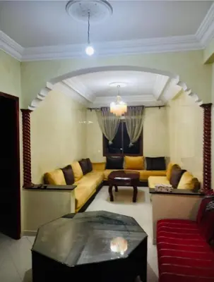 a living room with a couch and a table at Modern 2bedroom full furnished in downtown in Marrakech