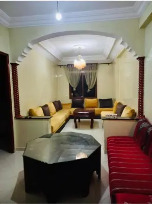 a living room with a couch and a table at Modern 2bedroom full furnished in downtown in Marrakech