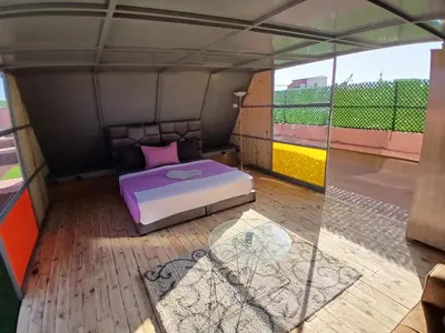 a room with a bed and a glass table at Chateau Nougat, Marrakech in Marrakech