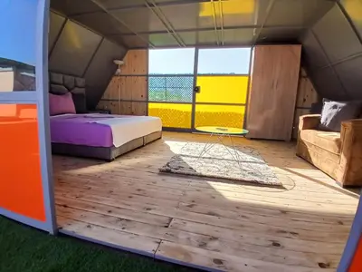 a bedroom in a tent with a bed and a couch at Chateau Nougat, Marrakech in Marrakech