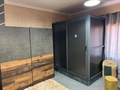a large black cabinet in a room with wood at Chateau Nougat, Marrakech in Marrakech