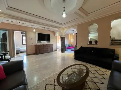 a large living room with a couch and a table at Comfort and Style in the Heart of the City - Villa T in Marrakech