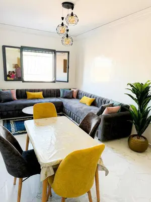 a living room with a couch and a table and chairs at marrakech geliz in Marrakech
