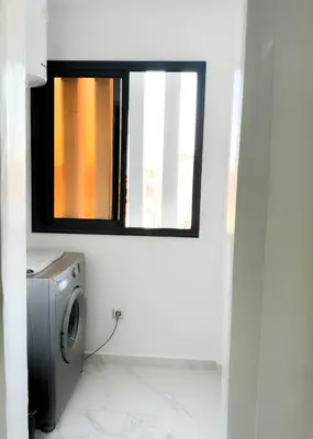 a washing machine in a bathroom with a window at marrakech geliz in Marrakech
