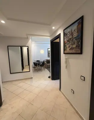 a living room with a mirror and a table at Elegant Apartment Marrakech in Marrakech