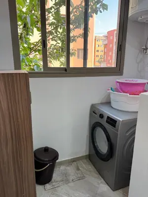 a washing machine in a room with a window at Appartement moderne et chic in Marrakech