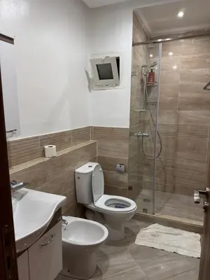 a bathroom with a toilet and a sink and a shower at Appartement moderne et chic in Marrakech