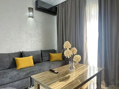 a living room with a couch and a table at Charmant & chic à Gueliz in Marrakech