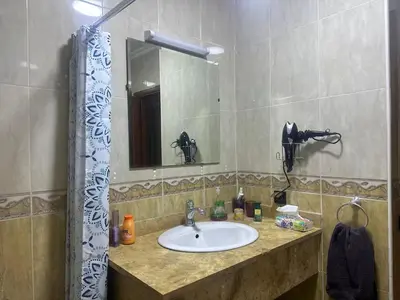 a bathroom with a sink and a mirror at Charmant & chic à Gueliz in Marrakech