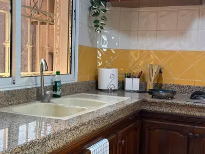 a kitchen counter with a sink and a window at Charmant & chic à Gueliz in Marrakech