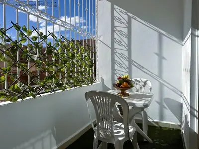 a balcony with a table and chairs and a window at Charmant & chic à Gueliz in Marrakech