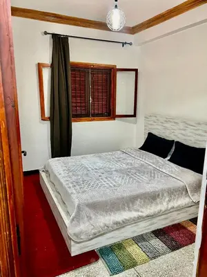 a bedroom with a bed in a room with a window at Mhamid airport in Marrakech