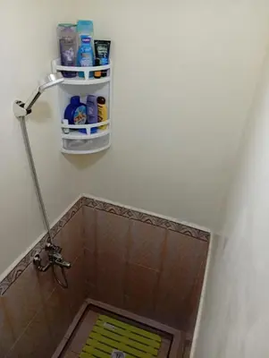 a bathroom with a shower with a tiled floor at Mhamid airport in Marrakech