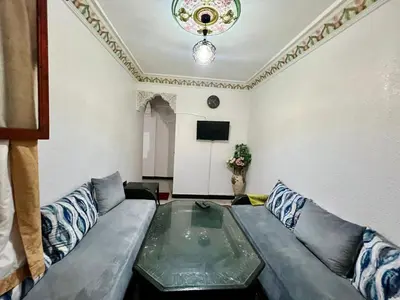 a living room with a couch and a tv at Mhamid airport in Marrakech