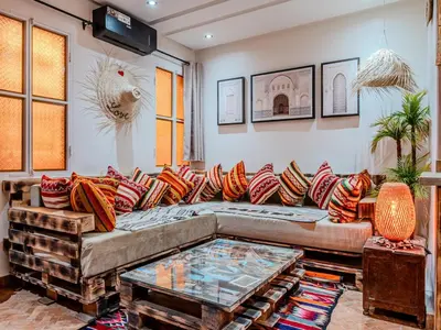 a living room with a couch and a table at Dar LalaFadma-Pvt 1BR Studio-1min to Bahia Palace in Marrakech