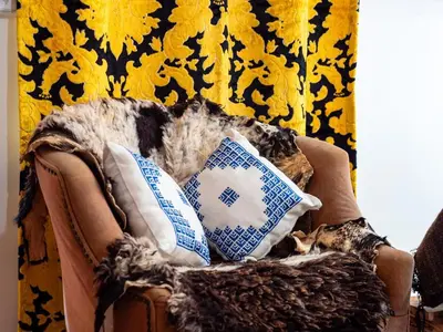 a chair with pillows and a cat sitting in it at Dar LalaFadma-Pvt 1BR Studio-1min to Bahia Palace in Marrakech