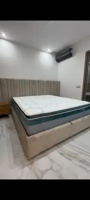 a bed sitting in a room with a mattressvisorvisor at Appartement de rêve in Marrakech
