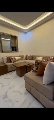 a living room with couches and a table and a couch at Appartement de rêve in Marrakech