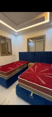 two beds in a room with blue dividers at Appartement de rêve in Marrakech