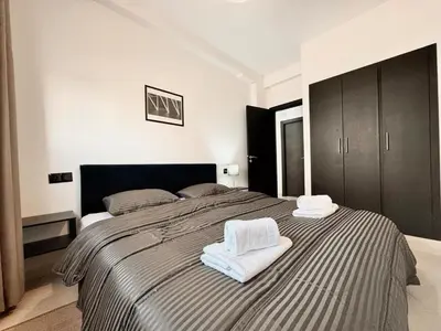a bedroom with a large bed with towels on it at Budget-Friendly 2BR - AC and heating in All Rooms in Marrakech