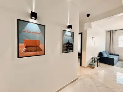 a living room with a couch and posters on the wall at Budget-Friendly 2BR - AC and heating in All Rooms in Marrakech