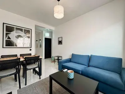 a living room with a blue couch and a table at Budget-Friendly 2BR - AC and heating in All Rooms in Marrakech
