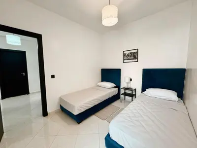 a bedroom with two beds and a mirror at Budget-Friendly 2BR - AC and heating in All Rooms in Marrakech