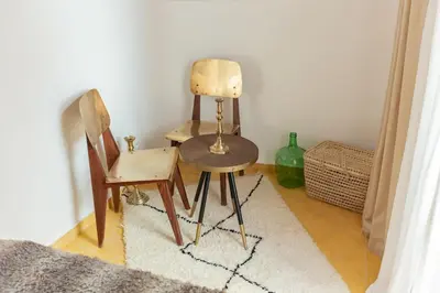 a room with two chairs and a table and a vase at Riad JONCHÈRES in Marrakech