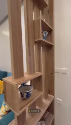a wooden shelf in a kitchen with some bowls on it at Appartement in Marrakech