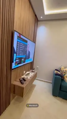 a room with a flat screen tv on a wall at Appartement in Marrakech