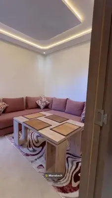 a living room with a couch and a table at Appartement in Marrakech