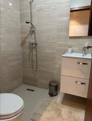 a bathroom with a shower and a toilet and a sink at Prestigia Jubaea Marrakech Argane in Marrakech