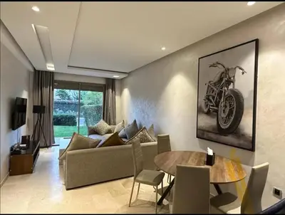 a living room with a couch and a table at Prestigia Jubaea Marrakech Argane in Marrakech