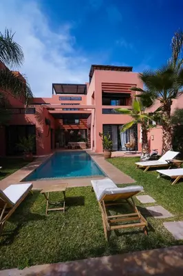 a resort with a swimming pool and lounge chairs at Golf el maaden Splendide villa in Marrakech