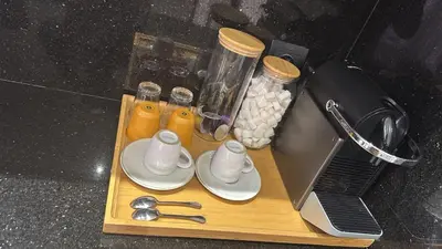 a wooden cutting board with a blender and cups and spoons at Golf el maaden Splendide villa in Marrakech