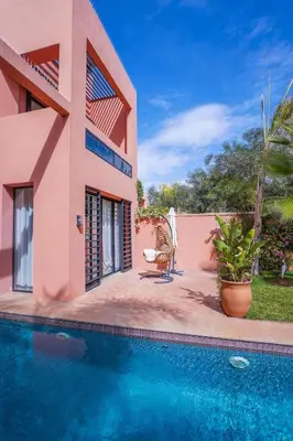 a house with a swimming pool in front of it at Golf el maaden Splendide villa in Marrakech